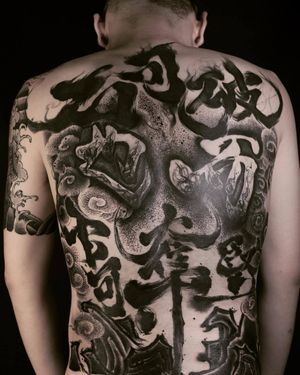 Transform your back into a work of art with Kotaro's intricate blackwork design featuring traditional Japanese motifs and kanji characters.