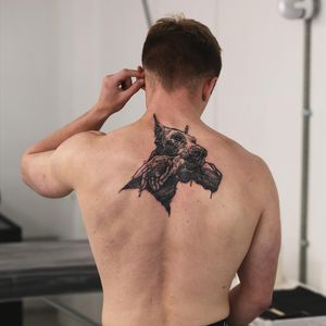 Unique and bold illustrative blackwork design of a dog by artist Jamie B, perfect for your upper back.