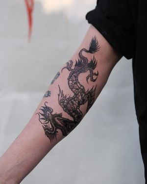 Experience the power of the mythical dragon with this intricately detailed blackwork tattoo by Jamie B.