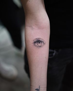 Fine line and micro realism style eye tattoo on forearm by talented artist Jamie B.