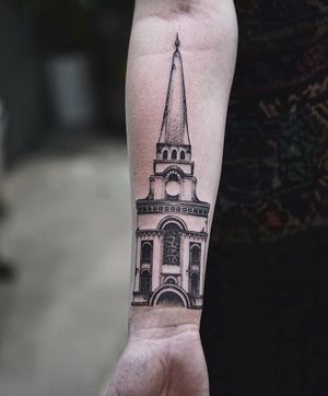 Blackwork forearm tattoo of a detailed church design by Jamie B, showcasing intricate linework and shading.