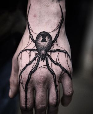 Intricate blackwork spider design by Jamie B on the hand for a bold and unique look.