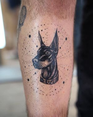 Get a bold and detailed blackwork tattoo of a dog on your lower leg by the talented artist Jamie B.