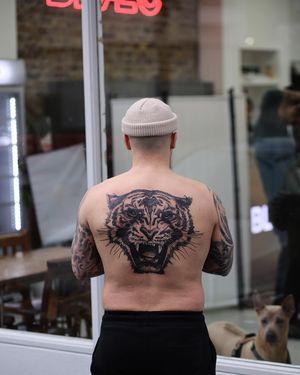 Impressive blackwork illustration of a fierce tiger, expertly done by Jamie B on the upper back.