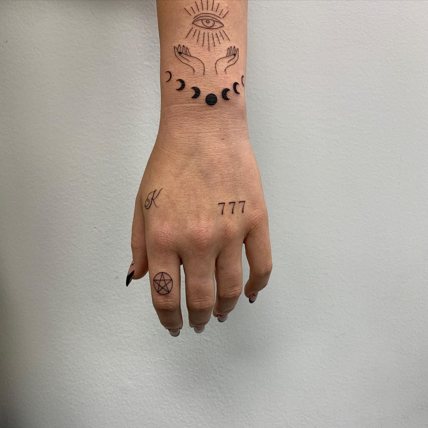 Number 777 tattooed on the wrist