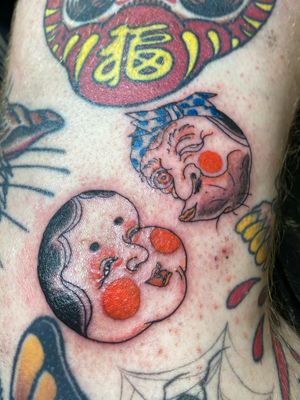 Mini Okame and Hyottoko on the side of the knee, tattooed at the Cult Classic Tattoo flash day 