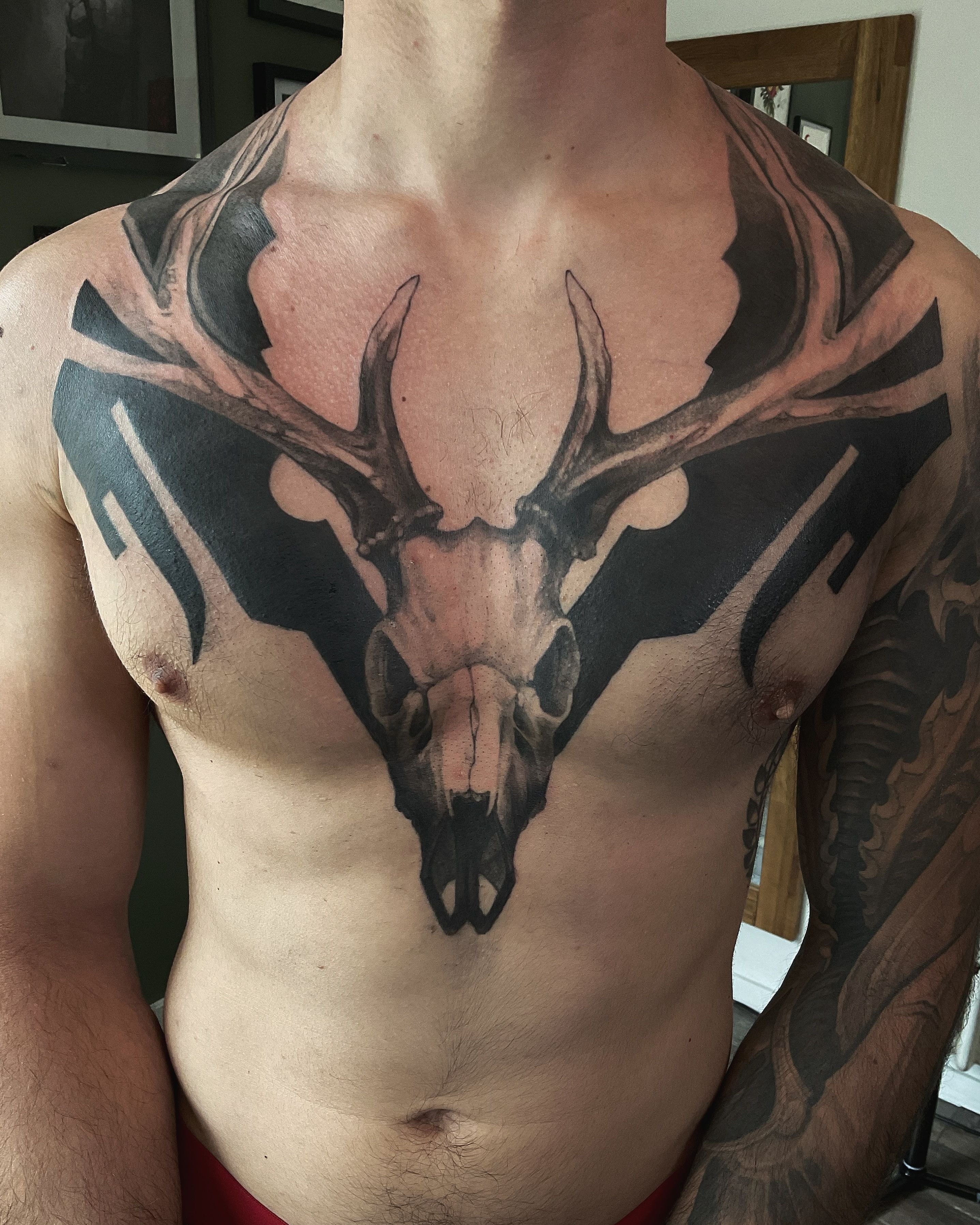 Deer tattoo on the chest.