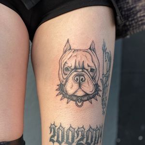 Capture your love for your furry friend with a stunning black and gray dog tattoo on your upper leg in London.