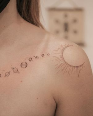 Get a stellar design of the sun and planets in fine line style on your shoulder. Perfect for astronomy lovers in Los Angeles!