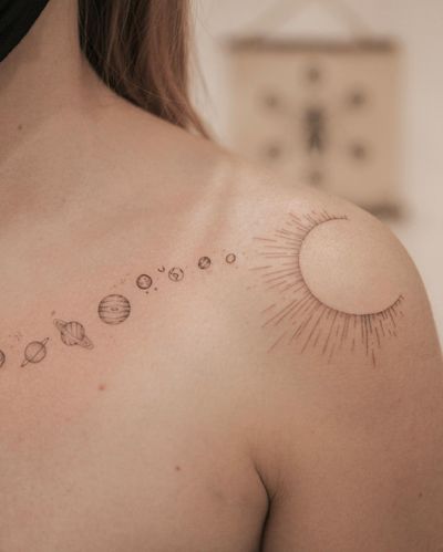 Get a stellar design of the sun and planets in fine line style on your shoulder. Perfect for astronomy lovers in Los Angeles!