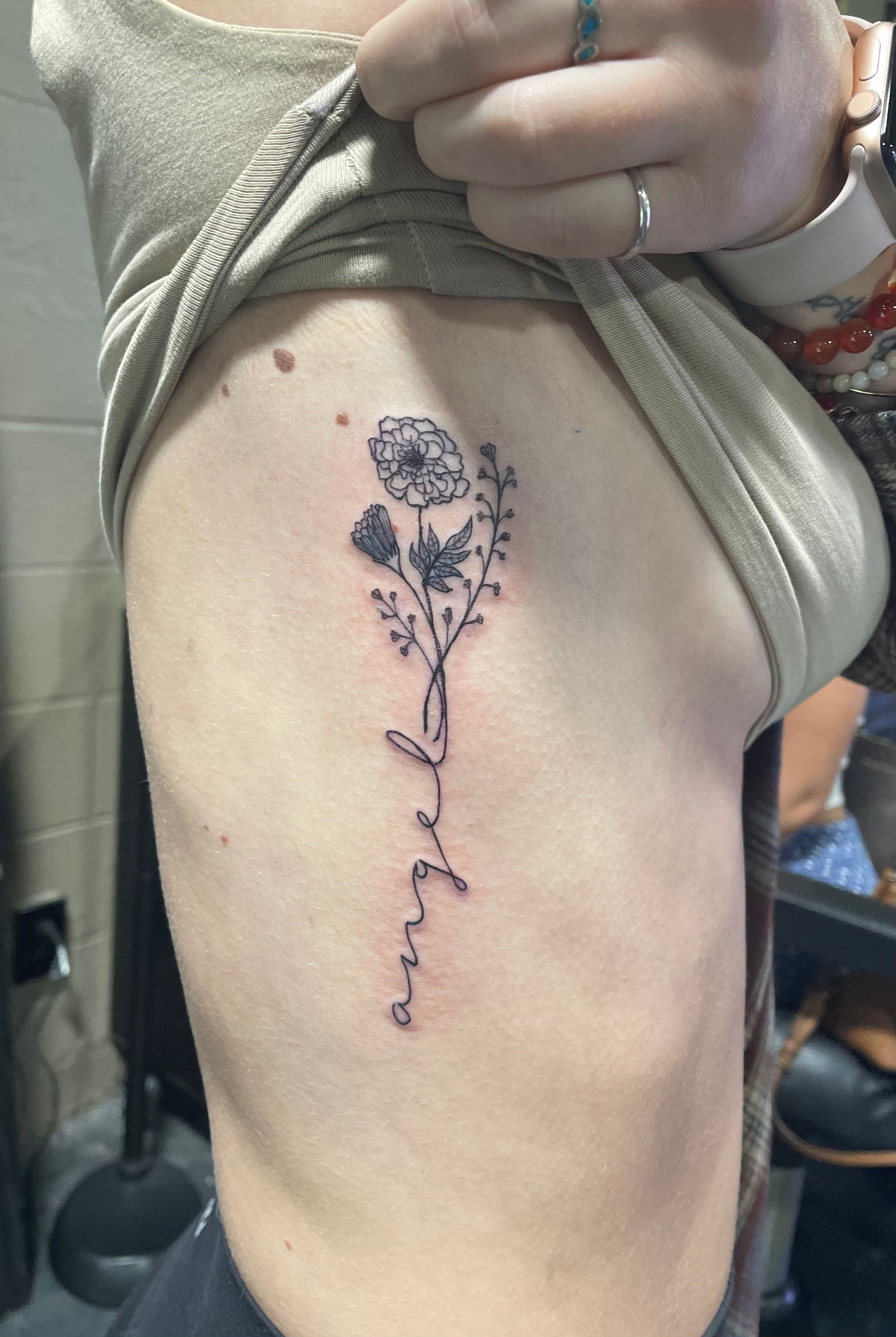 Black lily & stars flower tattoo on ribs