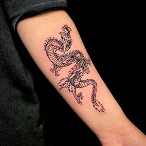 Get a stunning illustrative dragon tattoo on your forearm in London. Explore fine line details for a unique and artistic look.