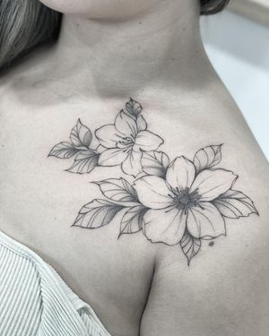 Beautiful blackwork flower design on chest by Lawrence combining ornamental and illustrative styles.