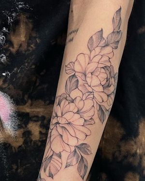 A stunning blackwork peony adorning the forearm, beautifully designed by skilled artist Lawrence.