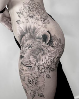 A stunning blackwork and dotwork design featuring a fierce lion, delicate peony flower, and intricate mandala, created by the talented artist Lawrence.