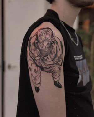 Get a stunning blackwork gohan tattoo on your upper arm by the talented artist Sofia. Perfect for Dragon Ball Z fans!