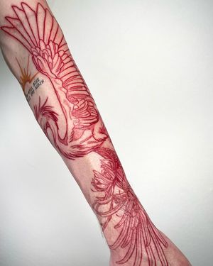 Sofia beautifully combines a chrysanthemum flower and elegant heron in this detailed illustrative forearm tattoo.