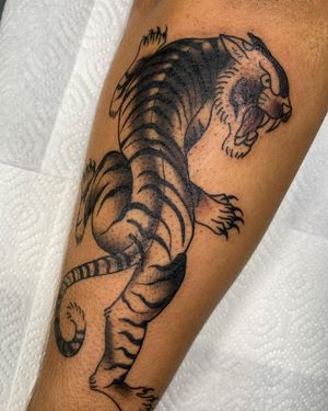 Get fierce with this blackwork panther design on your lower leg by talented artist Sofia.