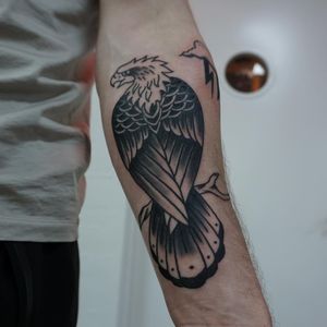 Get a stunning blackwork eagle tattoo on your forearm by the talented artist Sofia. Bold and detailed design for a timeless look.