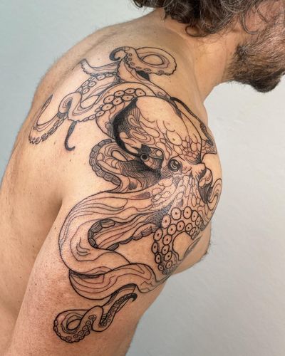 Beautiful blackwork octopus tattoo on shoulder, done by the talented artist Sofia. Add a touch of mystery and sophistication to your body with this unique design.