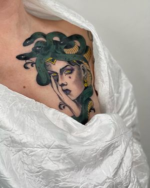 Neo-traditional chest tattoo featuring a captivating medusa intertwining with a woman, beautifully crafted by Sofia.