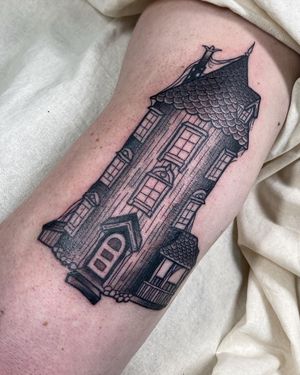 Capture the magic of a fairytale castle with this blackwork, illustrative tattoo on your upper arm. Designed by the talented artist Sofia.