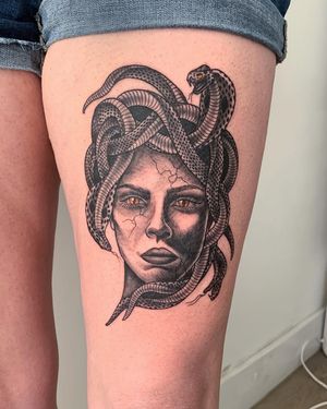 Experience the intricate beauty of Brigid Burke's blackwork design featuring a stunning snake and woman motif on the upper leg.
