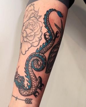 Experience the power and beauty of a Japanese dragon with this illustrative forearm tattoo by Brigid Burke.