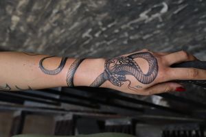Get an illustrative snake tattoo on your forearm by talented artist Jeppe Dahl Rørdam. Bold and stylish choice!