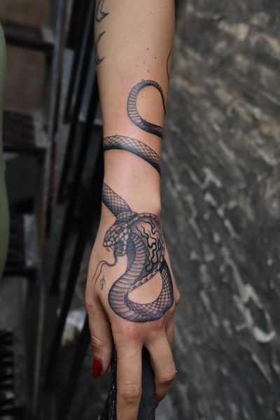 Get an illustrative snake tattoo on your forearm by talented artist Jeppe Dahl Rørdam. Bold and stylish choice!