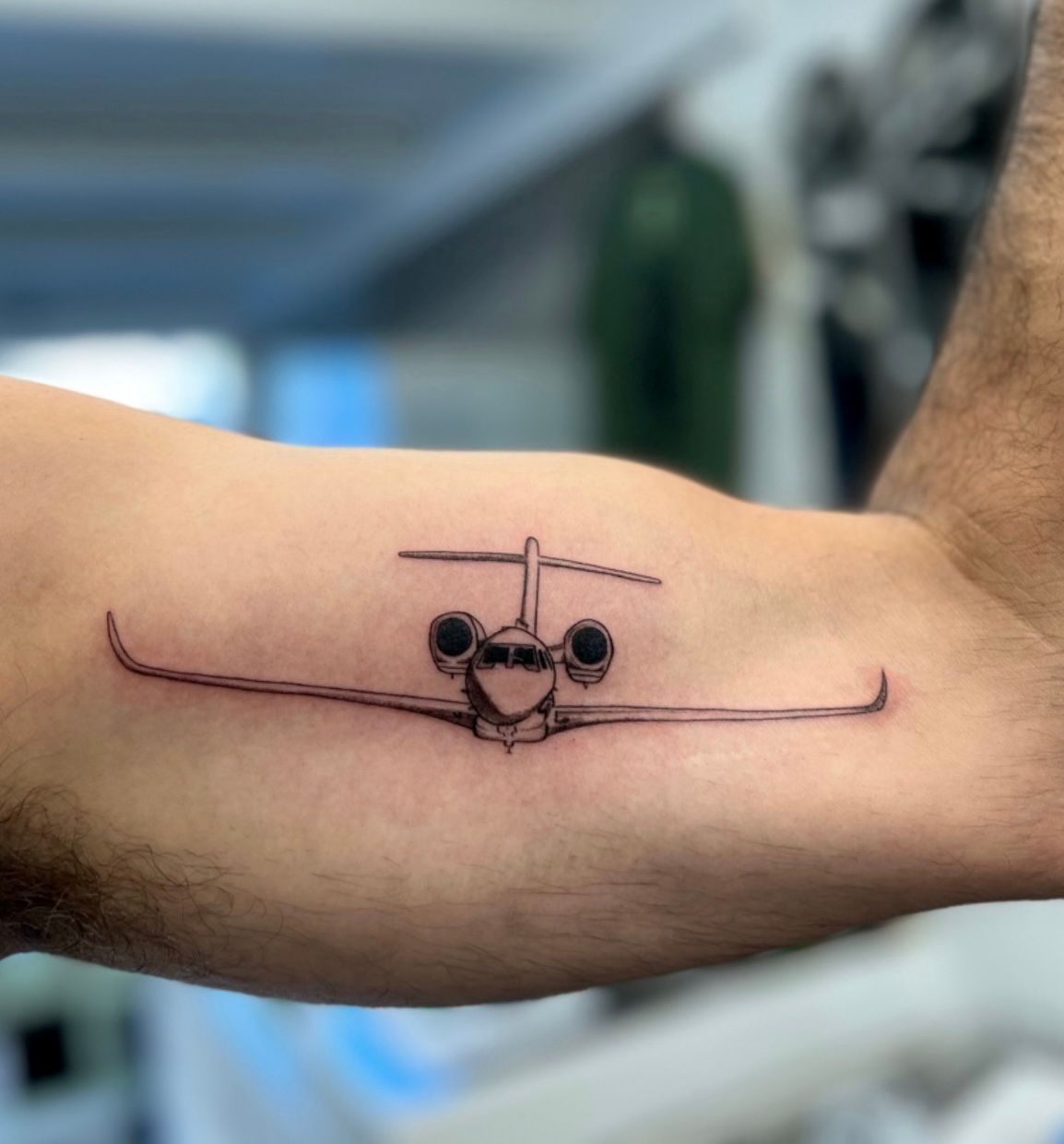 Micro airplane tattoo on the arm - Tattoogrid.net