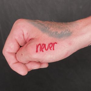 Lettering on the hand in red ink