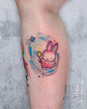 Get a beautiful and colorful rabbit, flower, and paw pattern tattooed on your lower leg by the talented artist Houssam.