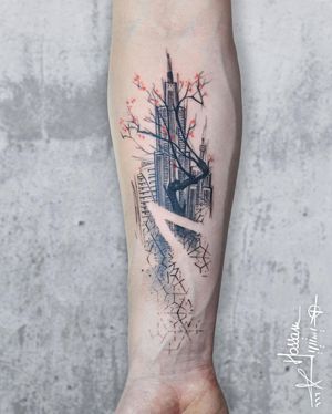 Get a stunning tattoo by Houssam featuring a tree, sakura, building, and cherry blossom patterns on your forearm. Perfect for those who love intricate blackwork designs.
