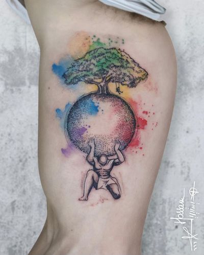 Unique upper arm tattoo combining a tree, pattern, world, and man, expertly done by artist Houssam