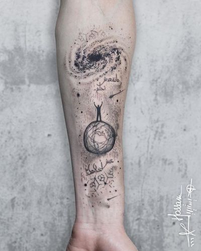 A unique forearm tattoo by tattoo artist Houssam, combining blackwork, fine line, and small lettering to create a geometric and illustrative design featuring a galaxy, world, man, and quote.