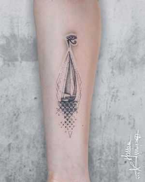An intricate forearm tattoo by Houssam featuring a geometric pattern with an eye of Horus and boat motif.