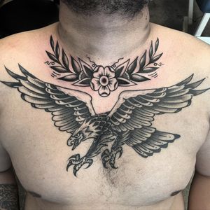 Bold blackwork illustration of an eagle and flower by artist Andre Bertoncin, perfect for a chest placement.