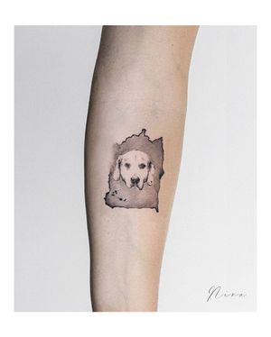Stunning blackwork tattoo of a dog on the forearm, expertly done by tattoo artist Nina.