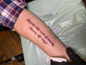 Fine line and small lettering forearm tattoo featuring a meaningful quote by artist Frankie Brown.
