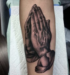 Unique forearm tattoo featuring a detailed blackwork hand design, expertly executed by tattoo artist Arlene Salinas.