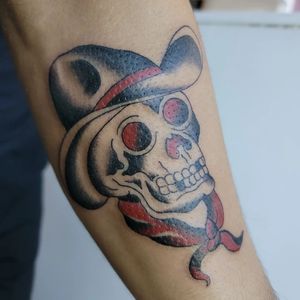 Add a touch of tradition to your forearm with a skull wearing a hat, expertly crafted by Arlene Salinas.