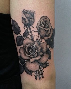 Blackwork tattoo of a beautiful flower by Arlene Salinas, adding an artistic touch to your upper arm.