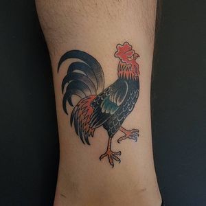 Traditional style rooster tattoo on arm by Arlene Salinas. Detailed and colorful design.