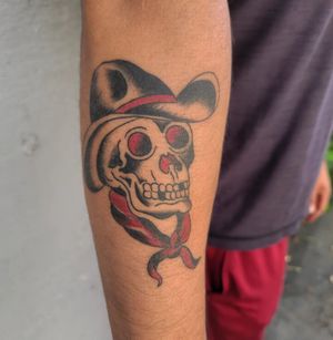 Get a classic traditional tattoo featuring a skull wearing a hat, done by the talented artist Arlene Salinas.