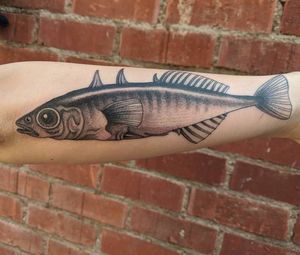 Experience the mesmerizing artistry of Arlene Salinas with this stunning blackwork fish tattoo on your forearm. A timeless and elegant choice for any tattoo enthusiast.