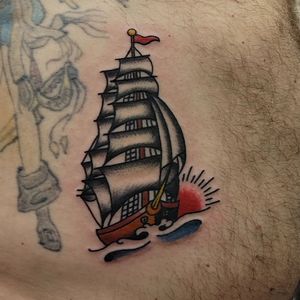Sail away with this illustrative ship tattoo by Arlene Salinas, featuring classic traditional style. Perfect for rib placement!