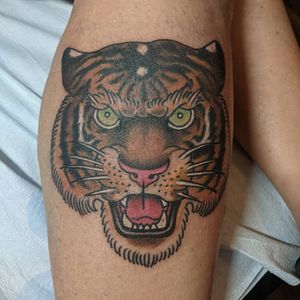 Capture the fierce beauty of a neo traditional tiger tattoo by Arlene Salinas on your lower leg.