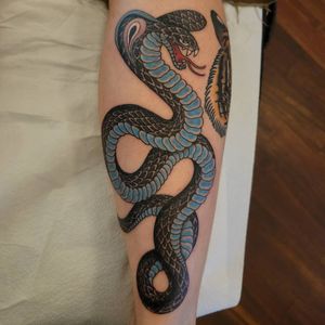 Experience the mystery and beauty of a Japanese-inspired snake tattoo on your forearm by the talented artist Arlene Salinas.