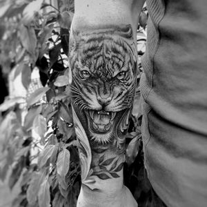 Get fierce with this stunning blackwork tiger tattoo by Murat Yılmaz. Perfect for those seeking a bold and eye-catching design.